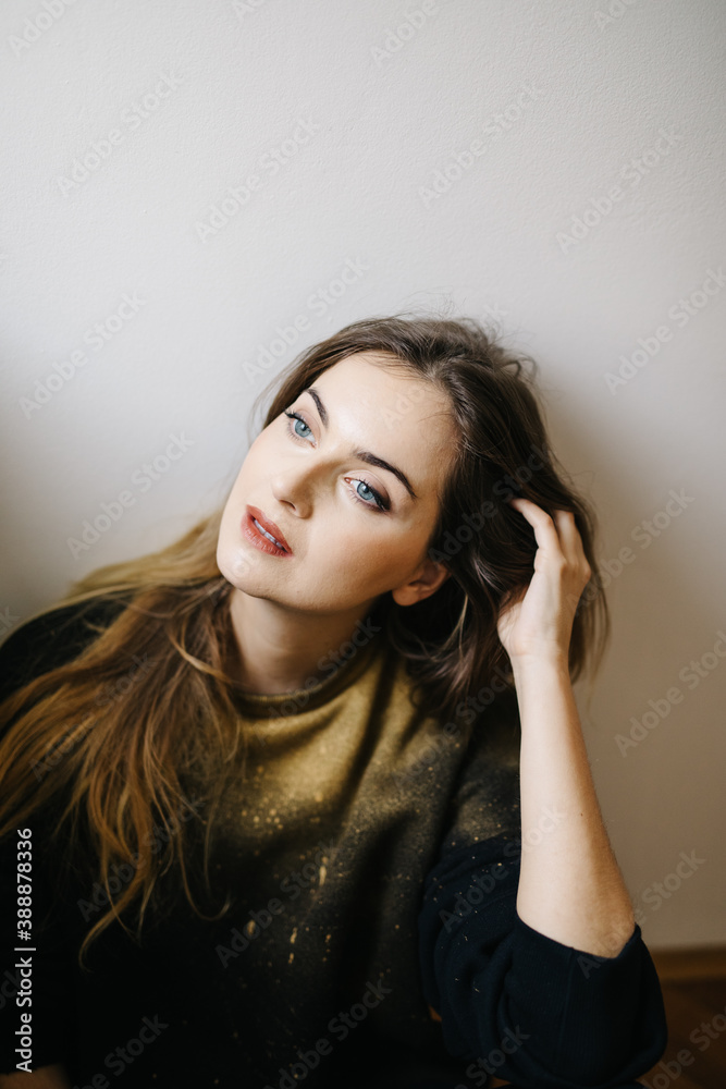 Thoughtful female sitting on floor Thoughtful female sitting on floor