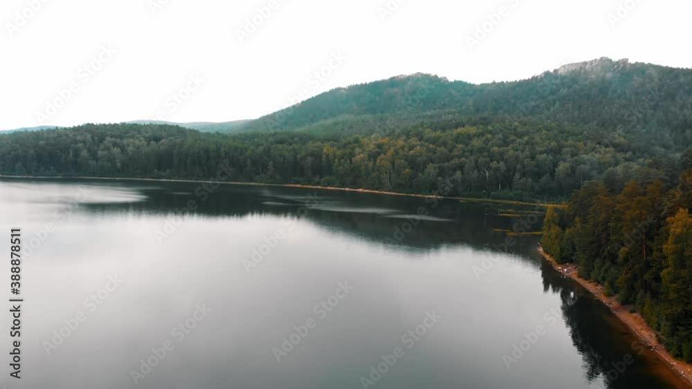 Landscape from dense coniferous forest and lake Landscape from dense coniferous forest and lake