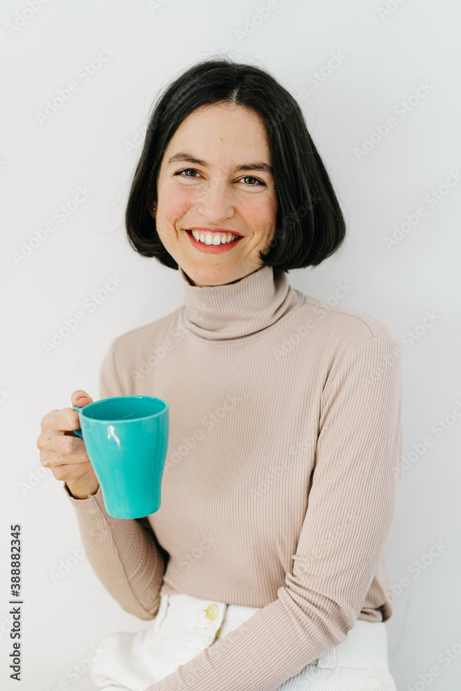 Cheerful sisters drinking hot beverage and chatting Cheerful sisters drinking hot beverage and chatting