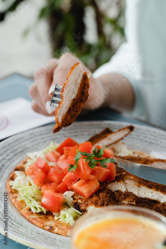 Eating Wiener Schnitzel With Fresh Salad. photo