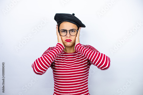Young beautiful brunette woman wearing french beret and glasses over white background thinking looking tired and bored with hands on head