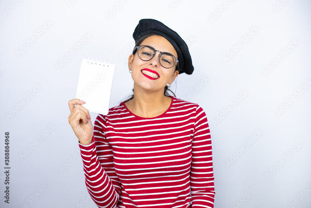 Φωτογραφία Young beautiful brunette woman wearing french beret and glasses over white backg
