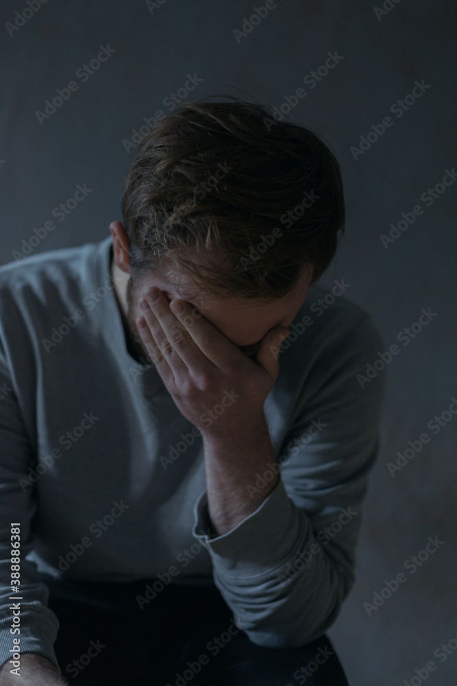 portraits of a guy in a depressed mood at home by a window in a dim light portraits of a guy in a depressed mood at home by a window in a dim light