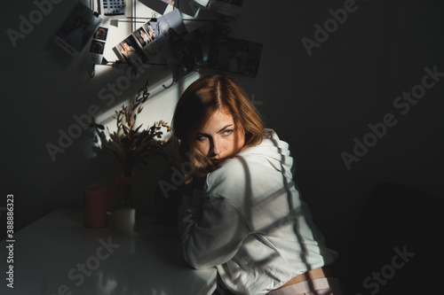 Girl looking back over her shoulder to sunlight.