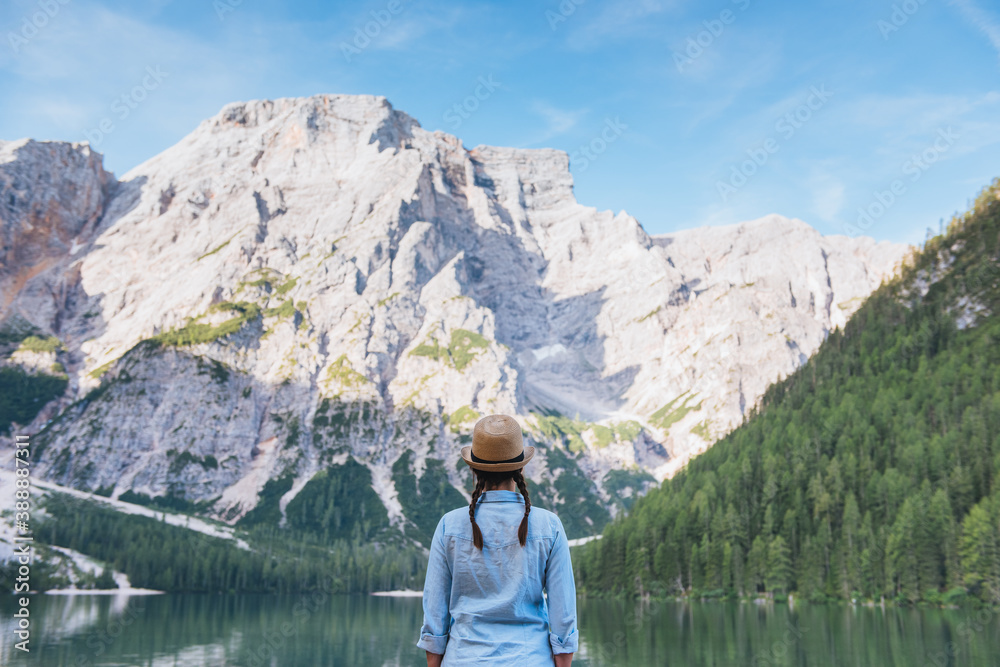 Woman looking at the mountain by the lake Woman looking at the mountain by the lake