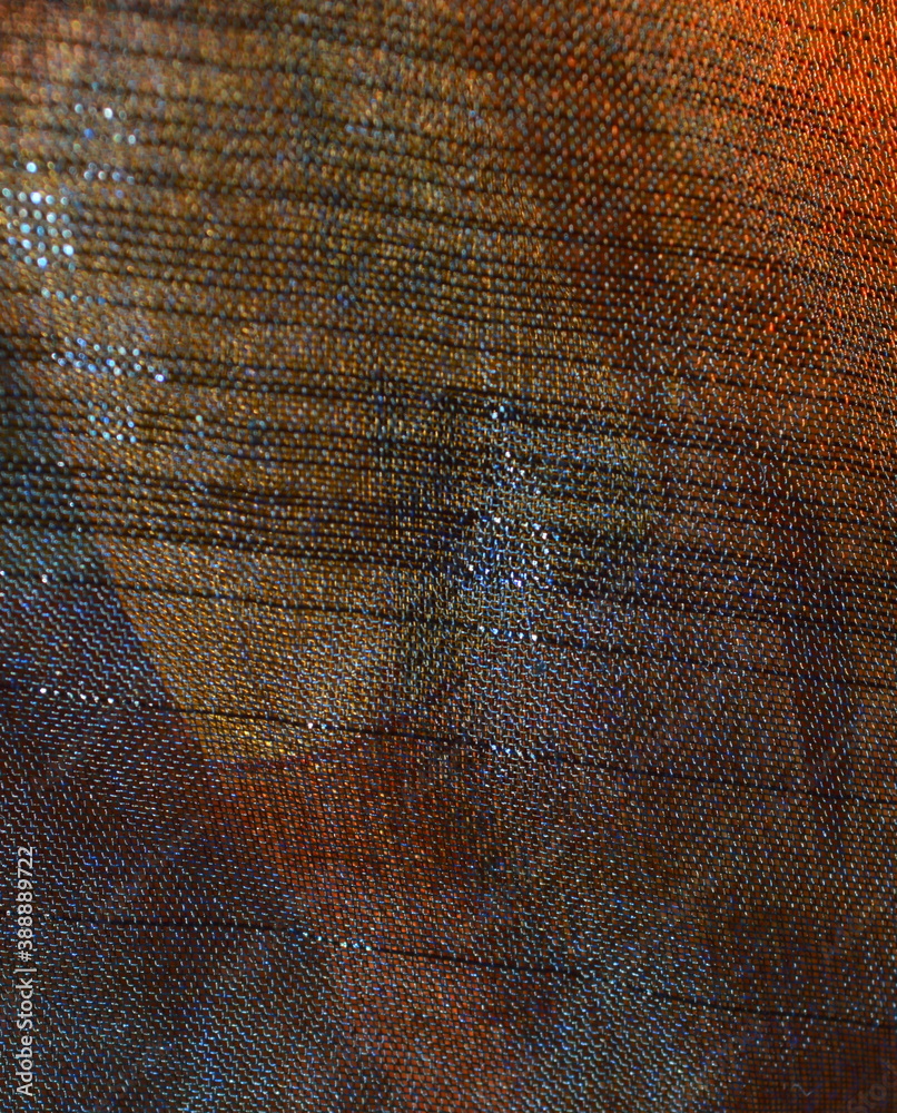 Φωτογραφία the texture of the background of the nylon fabric with iridescence from yellow t