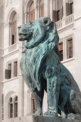 Sculpture of a lion sitting proudly on a pedestal