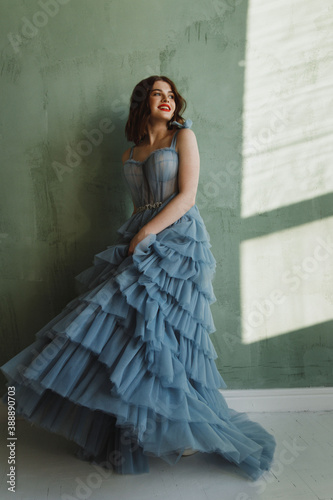 Girl trying on prom dress at home.