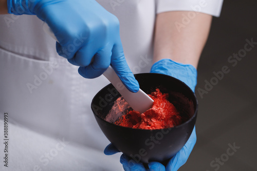 Cosmetologist preparing alginate mask. photo