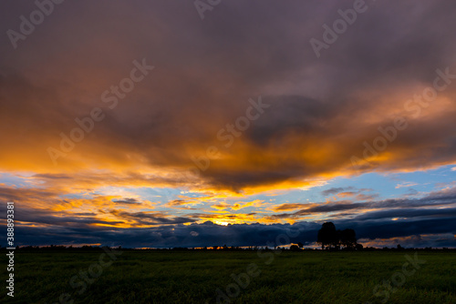 beautiful Sunset with dramatic sky clouds.Sunrise with cloud over rice field.Vivid sky on dark clouds.Long shots photo background for use.