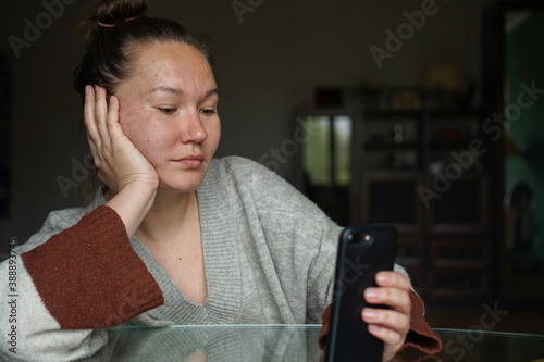 A woman using a phone to video chat