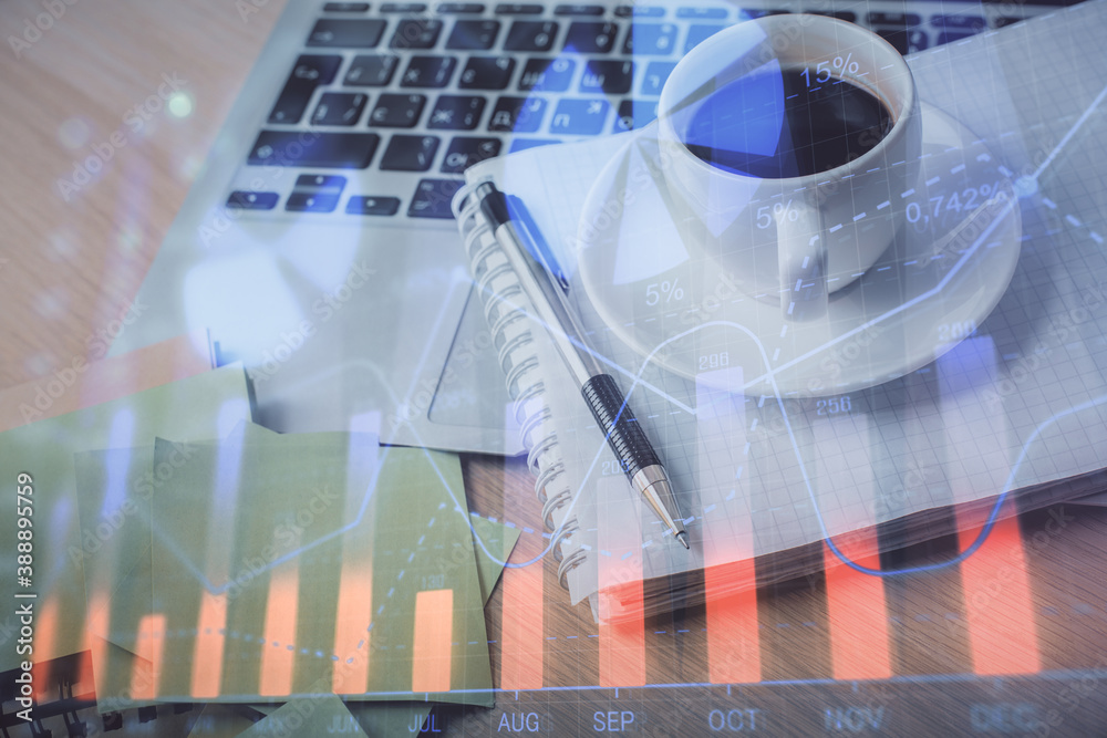 Double exposure of forex chart drawing and desktop with coffee and items on table background. Concept of financial market trading Double exposure of forex chart drawing and desktop with coffee and items on table background. Concept of financial market trading