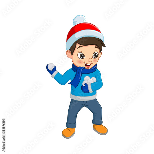Cute little boy in winter clothes throwing snowball