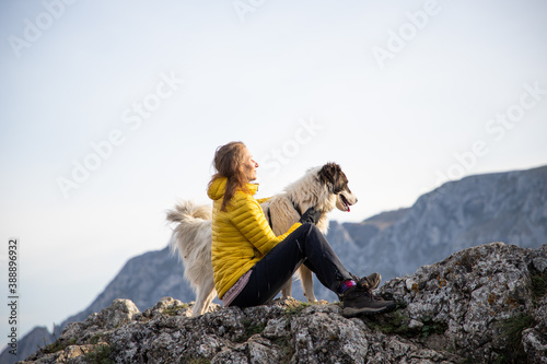 Obraz na plátně woman on mountain top with dog social distancing