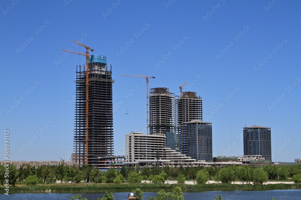 Skyscraper buildings under construction on the lake shore in China