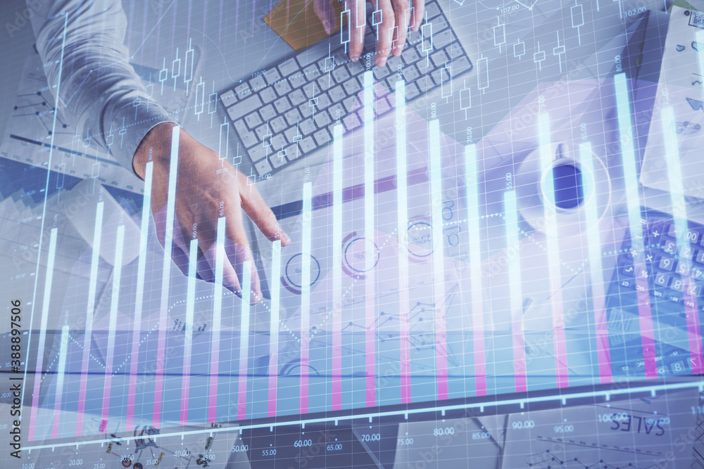 Multi exposure of man's hands typing over computer keyboard and forex graph hologram drawing. Top view. Financial markets concept. Multi exposure of man's hands typing over computer keyboard and forex graph hologram drawing. Top view. Financial markets concept.