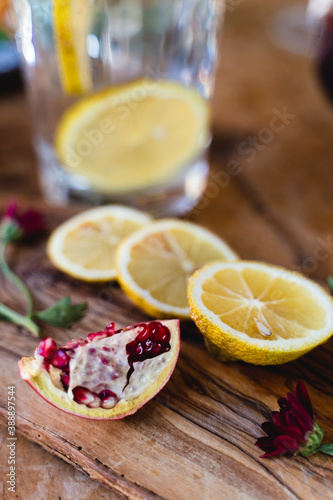 Slice of lemon and pomegranate kept on table