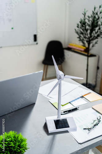 Wind turbine shaped electric fan standing on office desk photo