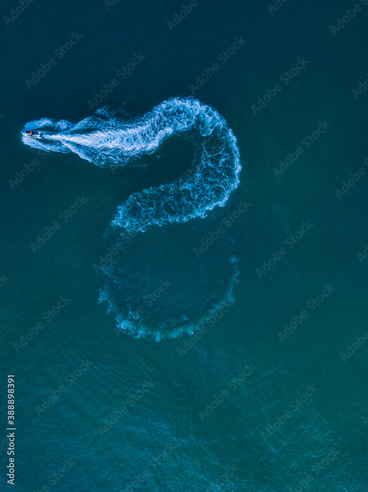 Aerial view of jet boat sailing in turquoise water Aerial view of jet boat sailing in turquoise water