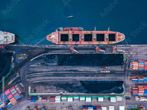 Russia, Primorsky Krai, Vladivostok, Aerial view of industrial ship moored in coal loading dock photo