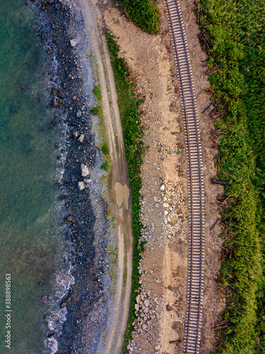 Aerial view of empty railroad tracks stretching along coast photo