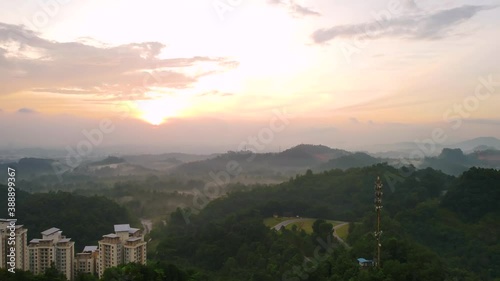 Aerial Drone 4K UHD anamorphic with Desqueeze factor of 1.15x 1.33x view of 5G Communication tower on top of hill view during beautiful sunrise.