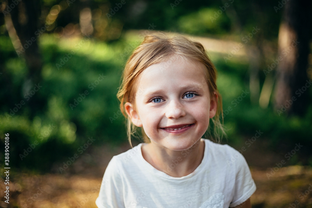 Portrait of cute smiling girl standing in forest Portrait of cute smiling girl standing in forest