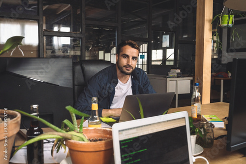 Portrait of businessman sitting at new workplace photo