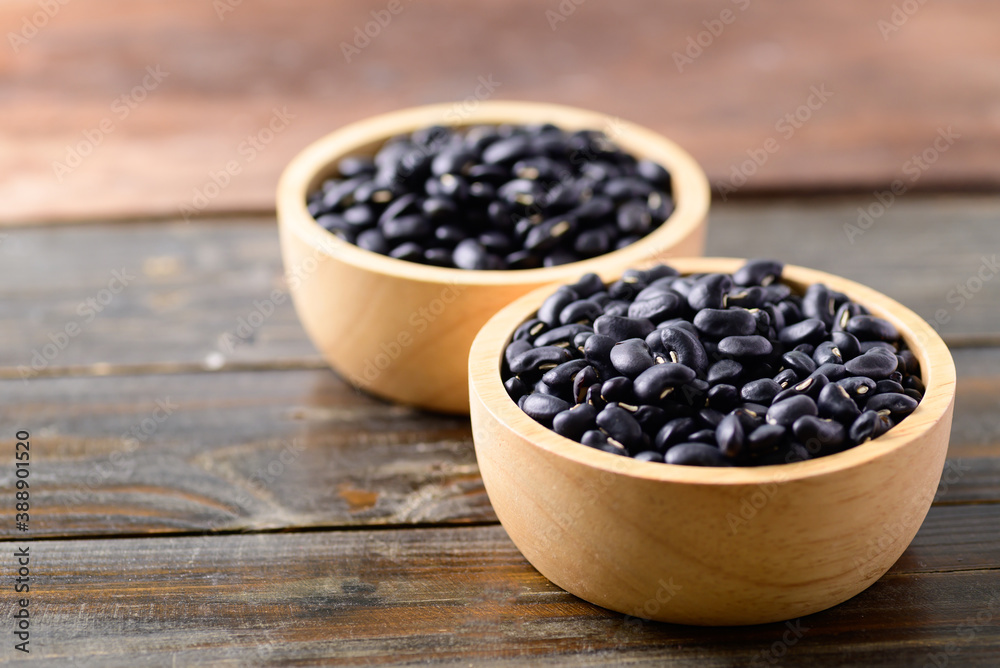 Black kidney beans in a bowl on wooden background Black kidney beans in a bowl on wooden background