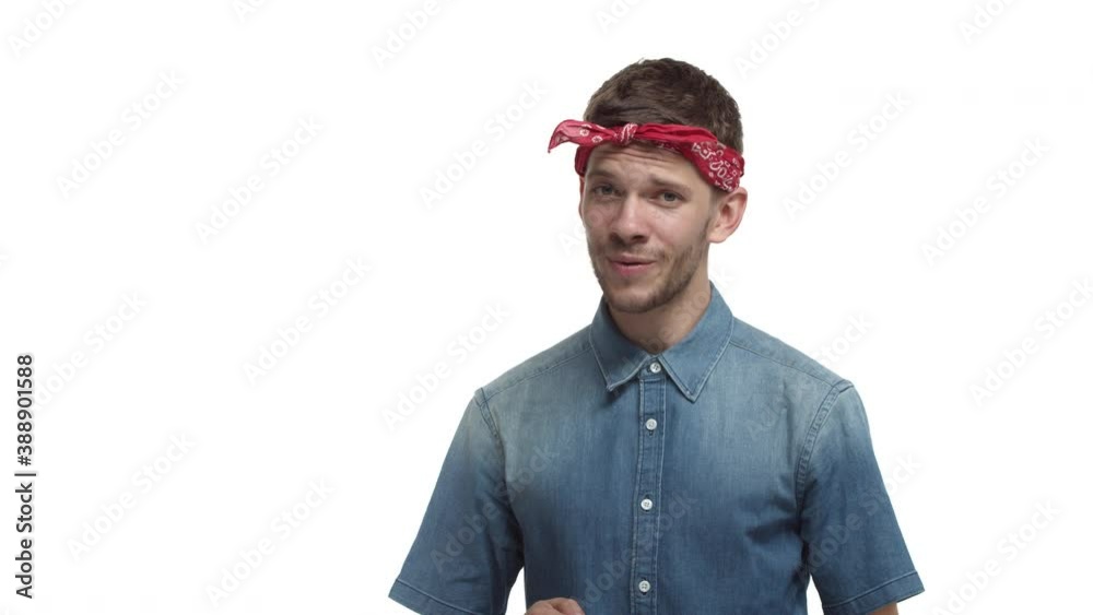 Handsome smiling guy with red headband, shaping heart in the air and looking lovely, express symapthy, like or love someone, standing over white background Handsome smiling guy with red headband, shaping heart in the air and looking lovely, express symapthy, like or love someone, standing over white background