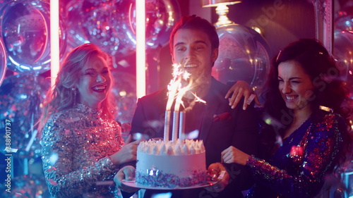 Photography Cute man and women holding cake at party