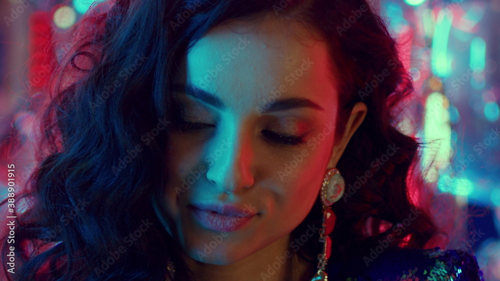 Smiling girl face in nightclub. Female person making facial expression in club Smiling girl face in nightclub. Female person making facial expression in club