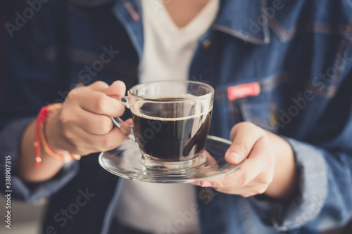 womand holding a cup of hot coffee