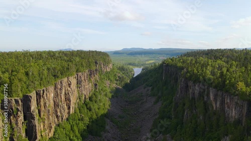 Aerial view down inside the Ouimet Canyon gorge, in a Provincial Park, in Dorion, Thunder Bay, sunny day, in Ontario, Canada - descending, drone shot photo