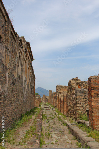View of Mount Vesuvious up an old street in the Ruins of Pompeii. No People, space for copy. photo