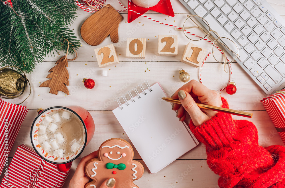 Fototapeta premium Office Workplace with Computer keyboard, empty notebook and Christmas Decoration.