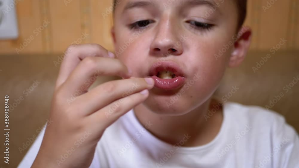 Hungry Caucasian Teen Puts Croutons in Mouth with Hand. Boy Eats Fast Food. Hungry Caucasian Teen Puts Croutons in Mouth with Hand. Boy Eats Fast Food.
