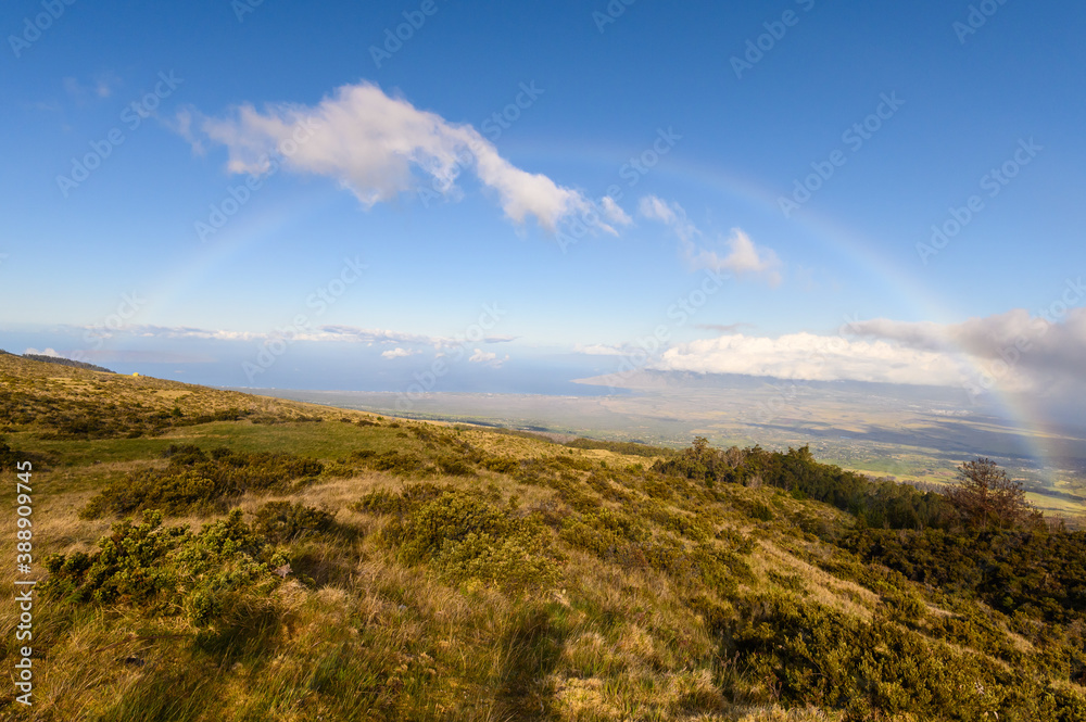 Full rainbow seen from the road to Haleakala National Park. Maui, Hawaii.