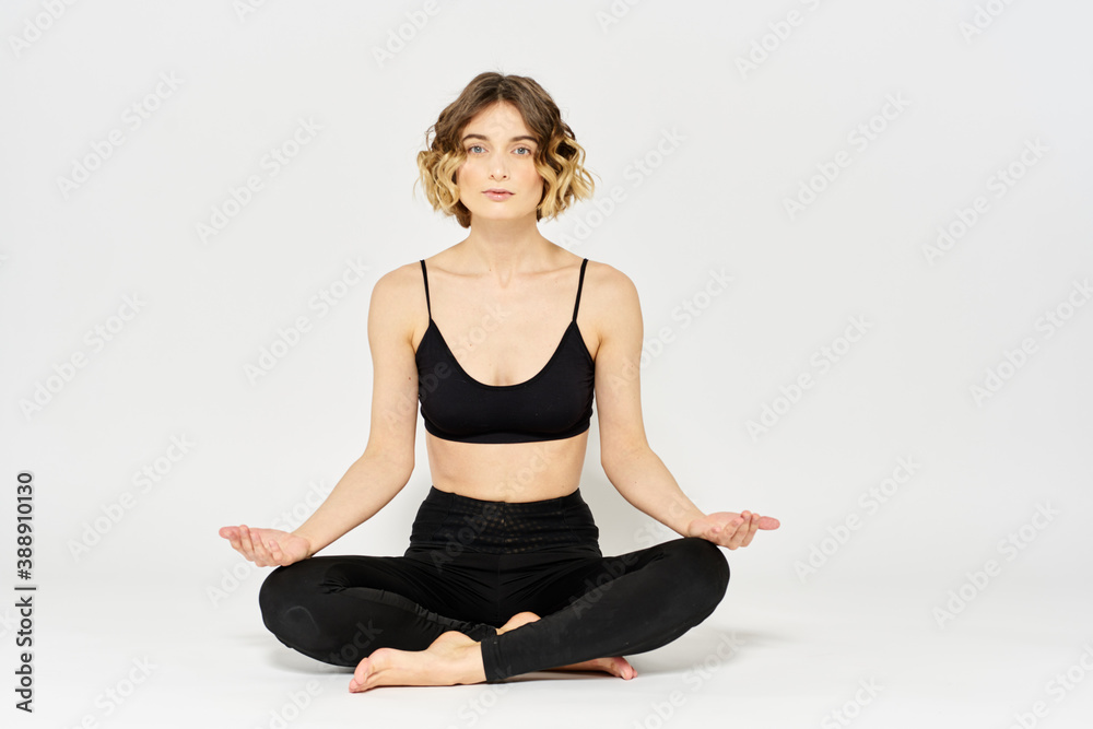 Yoga asana woman crossed legs meditation light background room