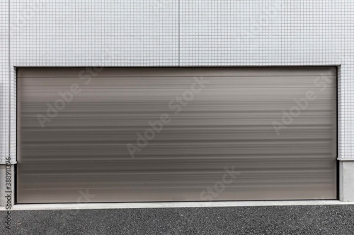 Automatic garage door large white shutter is closed © torsakarin