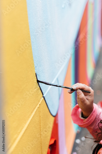 Artist painting a wall with a brush photo