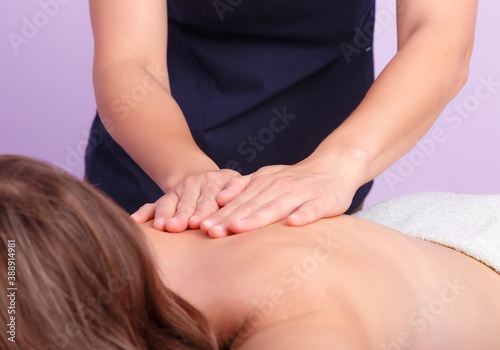 Hands of masseur doing massage of spine in a salon