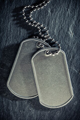 American military dog tags. Rough and worn with blank space for text. Memorial Day or Veterans Day concept.