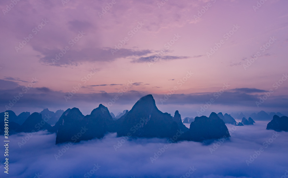 Sunset scenery of the mountains surrounded by clouds