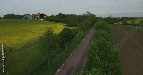 Flying Above Moving Trees By Countryside Road in South Sweden Skåne, Österlen Tosterup, Aerial Medium Foward photo