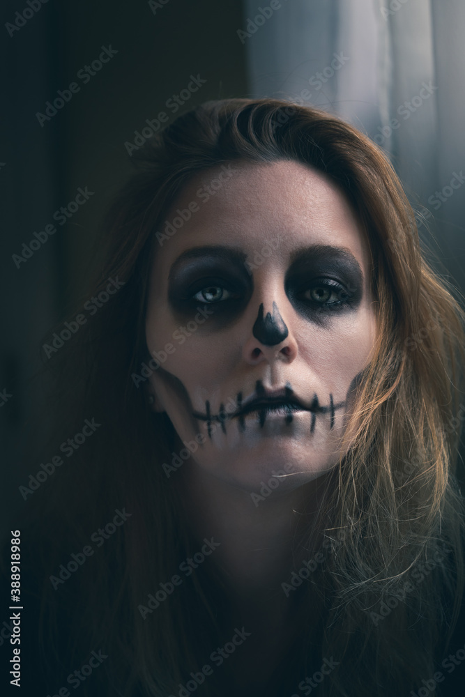 portrait of a woman with skull makeup 