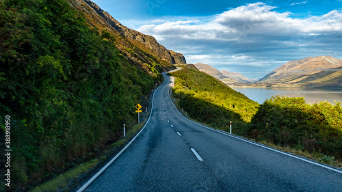 Long and winding highway on the edge of the stunning lake Wakatipu near Queenstown bordered by the Southern Alps © Stewart