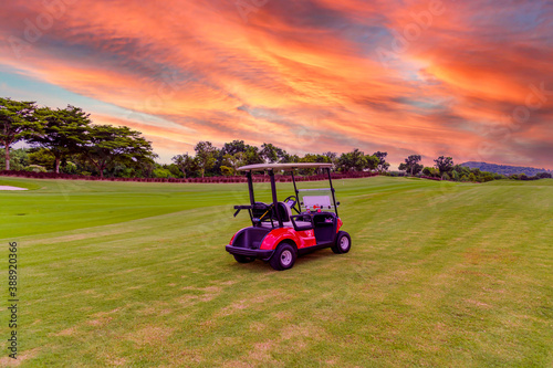 golf cart park on green grass with golf course view with sun sky background