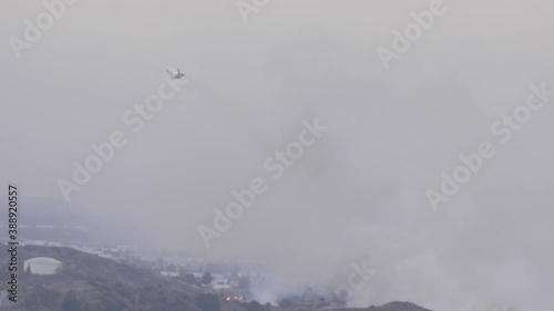 A Cal Fire McDonnell Douglas MD-87 departs after making a large retardant drop on the Silverado Fire in Southern California photo