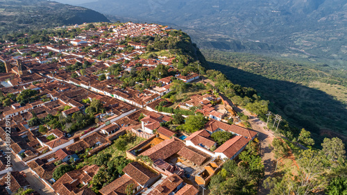 Aerial view panorama of historic town Barichara, Colombia with white cloud covered mountain ridge in background